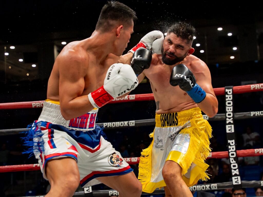 Weljon Mindoro lands a punch to his opponent Elias Espadas.