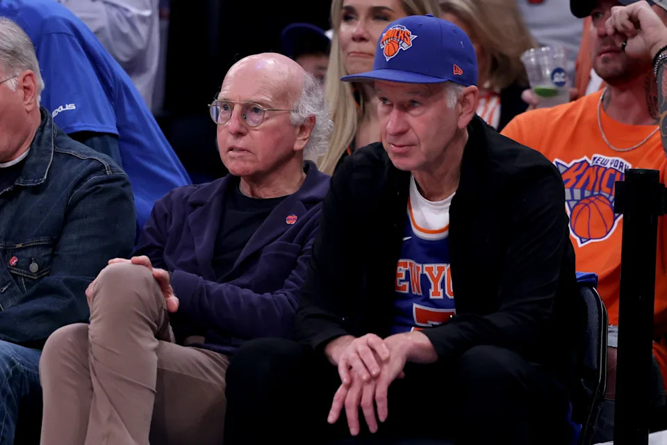 Larry David and John McEnroe courtside.