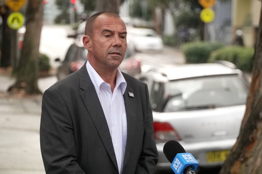 Nathan Moran talks to a reporter out in the streets