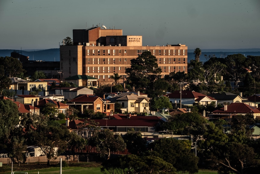 A large multi-storey hospital building in the city of Whyalla with houses in the foreground.