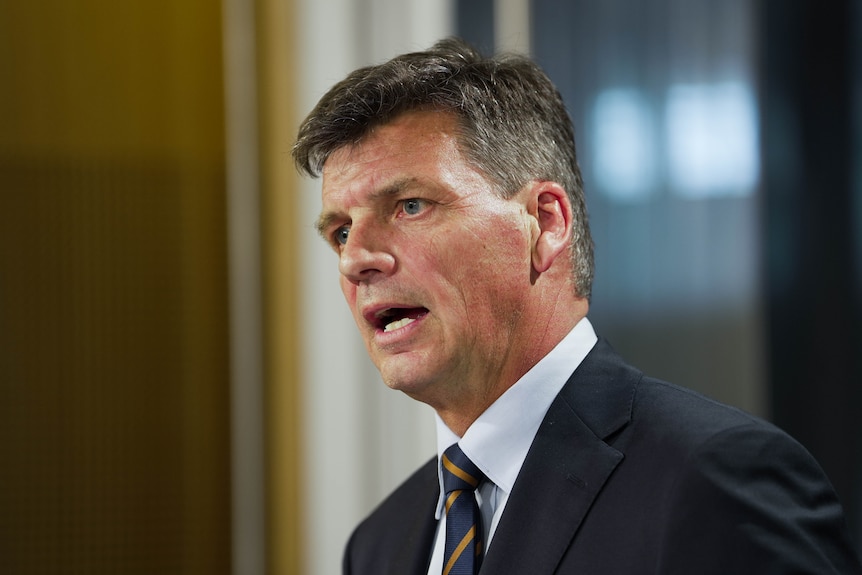 An older man wearing a suit gives an impassioned speech.