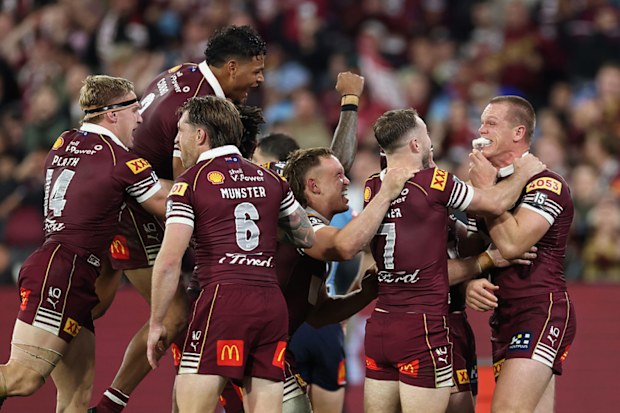 Queensland players celebrate after Lindsay Collins scored a try.
