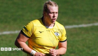Abi Burton looking on wearing Trailfinders' away yellow kit