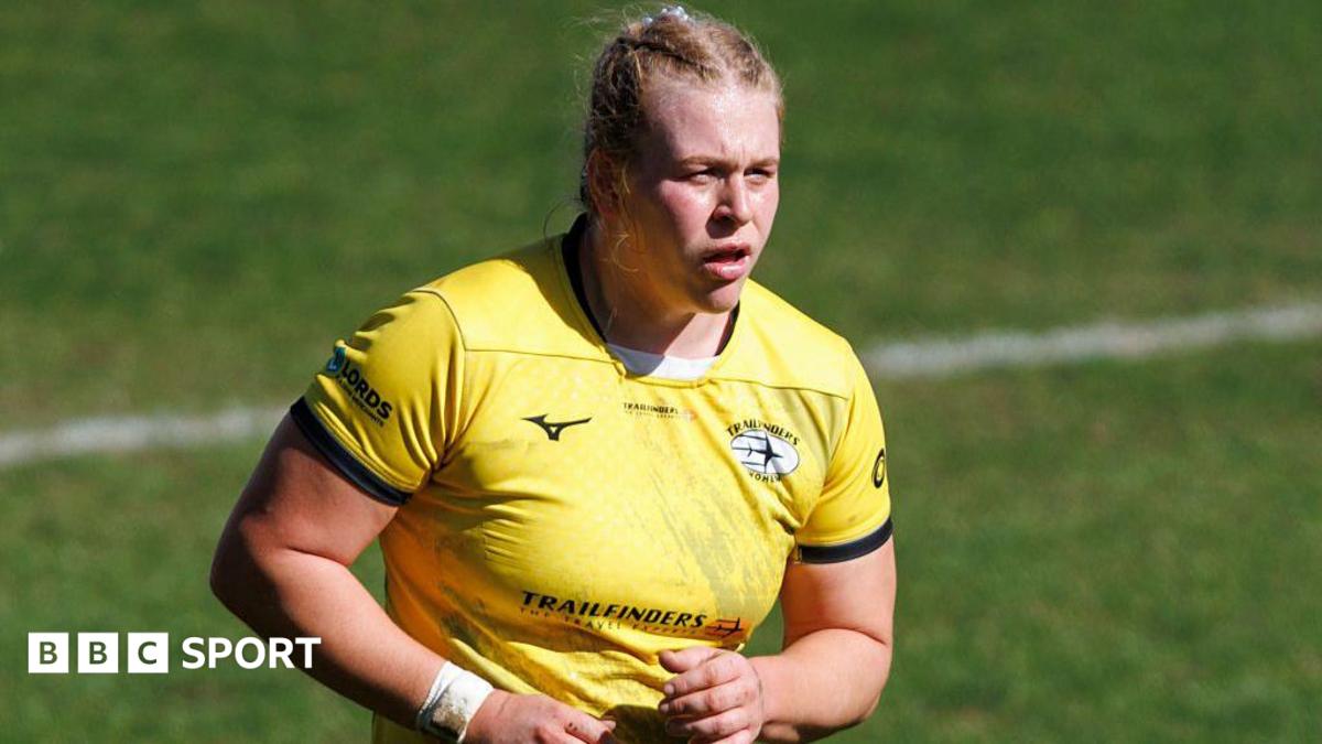 Abi Burton looking on wearing Trailfinders' away yellow kit