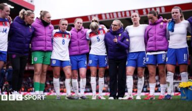 Sarina Wiegman in a huddle with England players