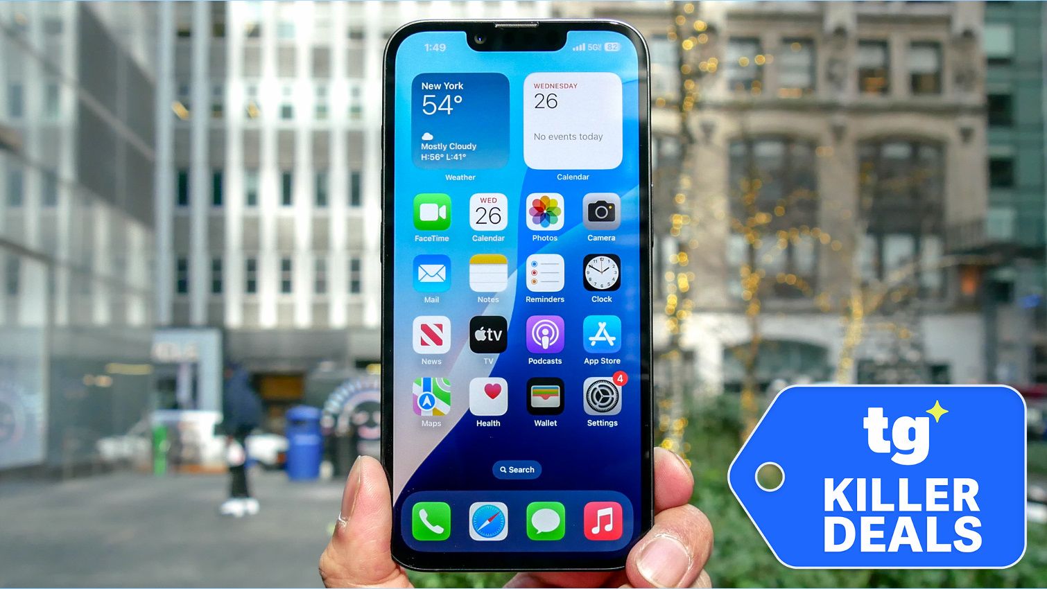 iPhone 16e held in hand with deal badge.