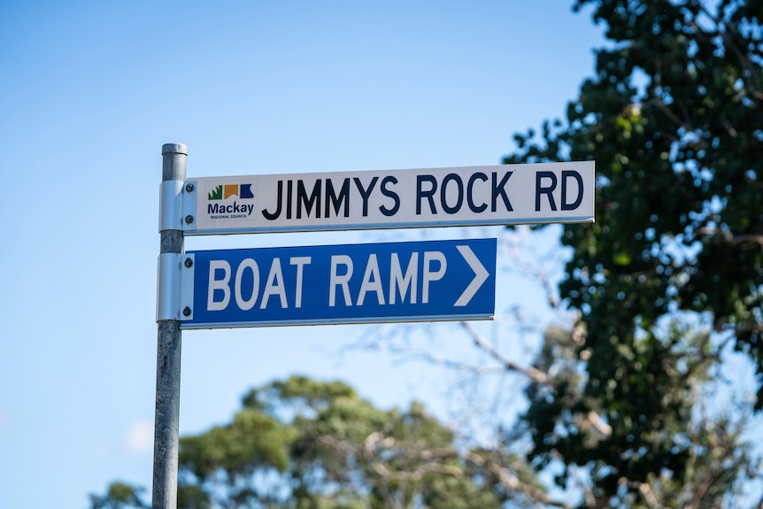 A sign reading Jimmys rock road and boat ramp