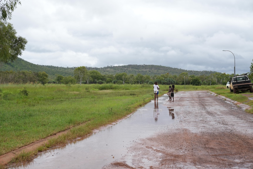 Aboriginal children playing on wet streets