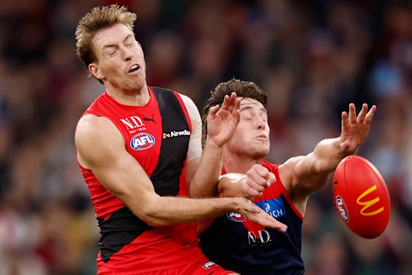 Essendon’s Will Setterfield clashes with Melbourne’s Tom Sparrow.