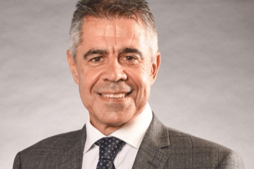 A head shot of a man wearing a suit and tie.