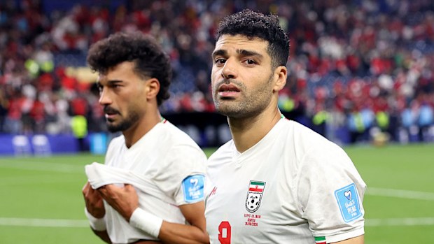 Ramin Rezaeian (L) and Mehdi Taremi (R) of Iran react after the 1-1 draw