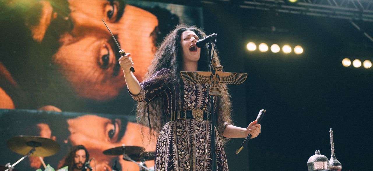 Nina Saeidi with a sword on stage