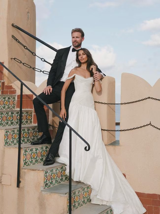 The model wore a corseted dress for the vow exchange in Italy before changing into a sheer lace dress for the evening.