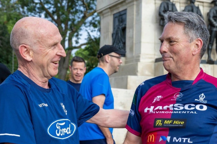 Two men shaking hands and smiling