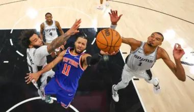 New York Knicks guard Jalen Brunson drives to the basket past San Antonio Spurs forwards Julian Champagnie and Victor Wembanyama during Game 2 of the NBA Finals.