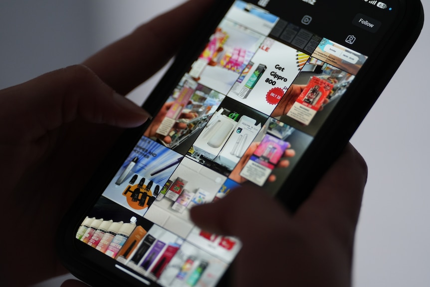 A person scrolling through Instagram stories about vape products on a mobile phone.