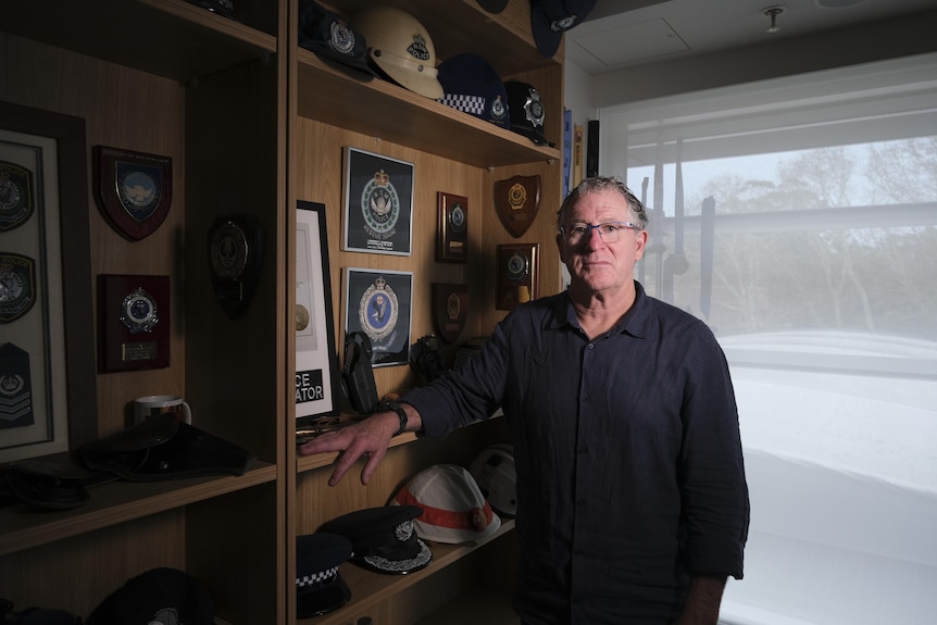 Vince Hurley with his police medals at home