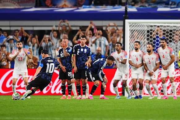 Messi takes the free kick.