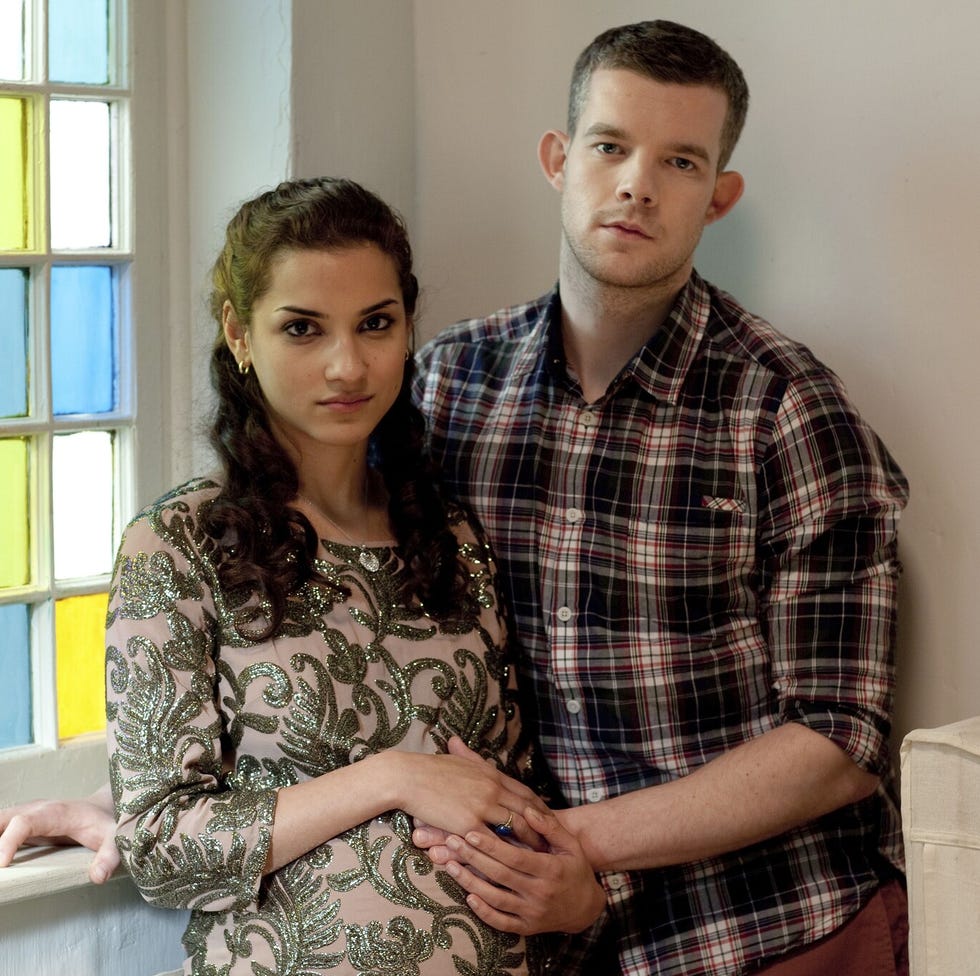 couple posing together in a brightly colored room couple posing together in a brightly colored room