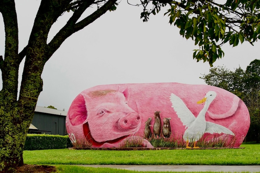 Round sculpture painted as a pink pig