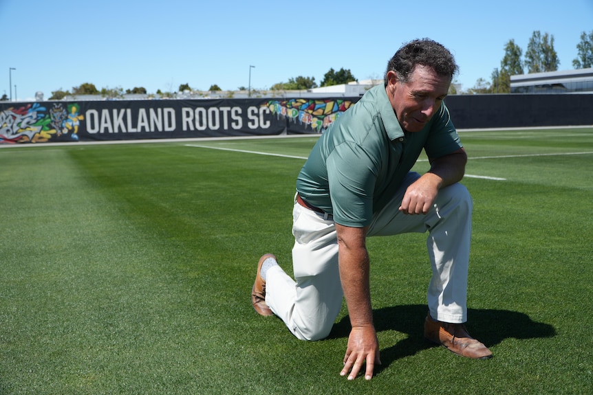 Marc Logan, curator of the Oakland Rootys and Soul Sports Club toiuches the grass