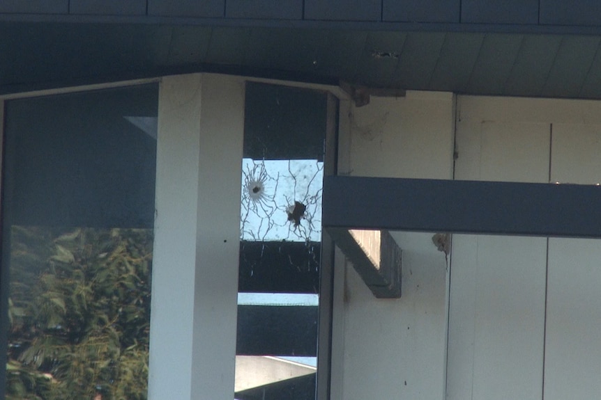 a window with a hole after it was shot