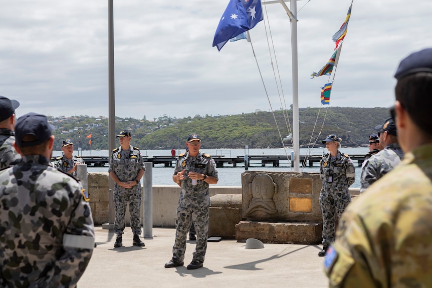 Naval officers speaking at the HMAS Penguin site.