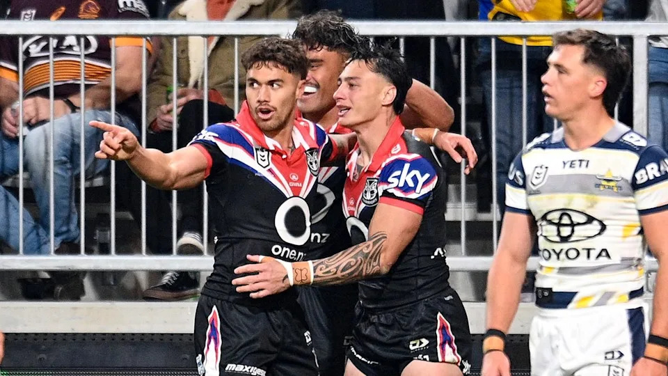 Warriors players celebrate a try.