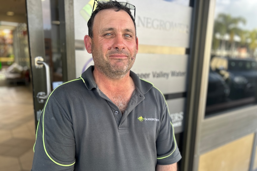 A man in a canegrowers shirt looking at the camera