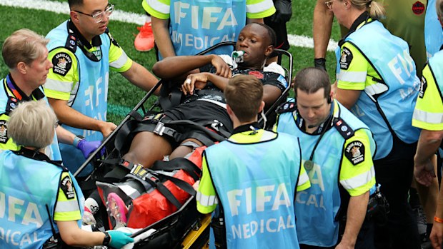 Canada's Ismael Kone is stretched off after being fouled by Assim Madibo.