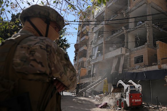 A soldier stands at the site where an Israeli airstrike hit a building in Dahiyeh, a southern suburb of Beirut, Lebanon, on Sunday.