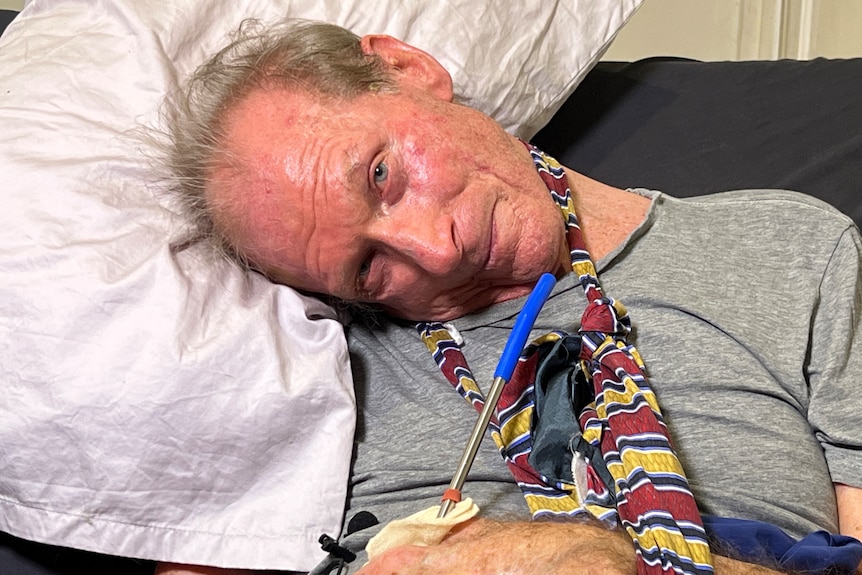 a man with his head resting on a pillow at a sharp angle.