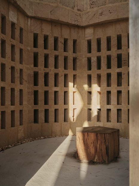 A careful matrix of small funerary-urn niches within each tower expresses a social and non-hierarchical approach to interment.