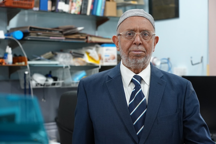An experienced journalist sits at a desk.