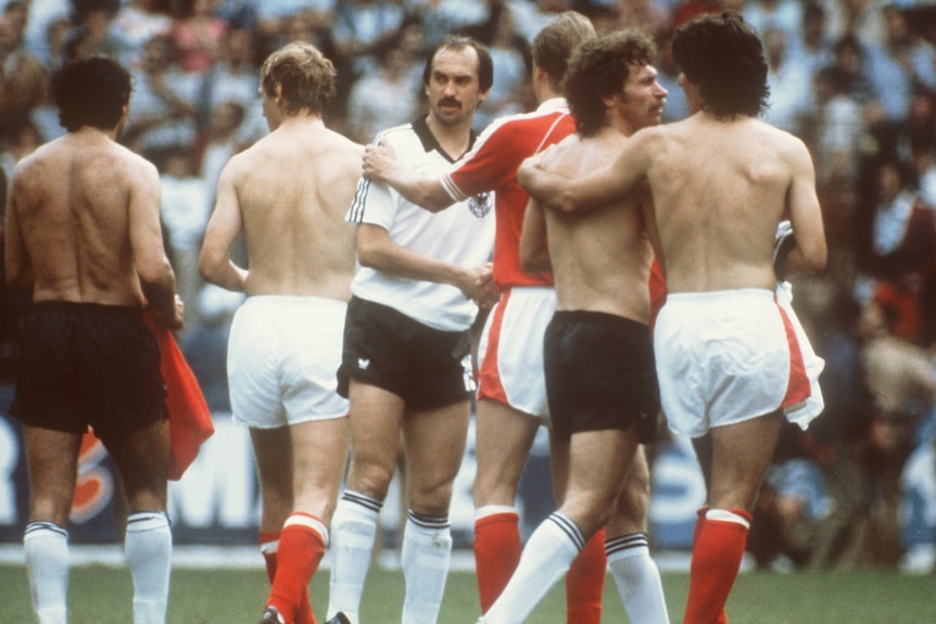 A group of soccer players shake hands after a match