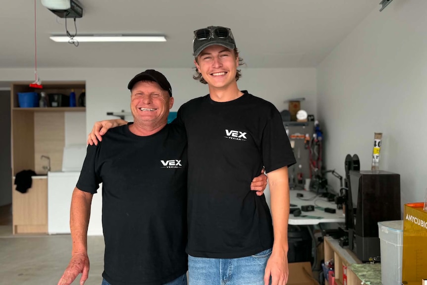 Two men smiling in garage
