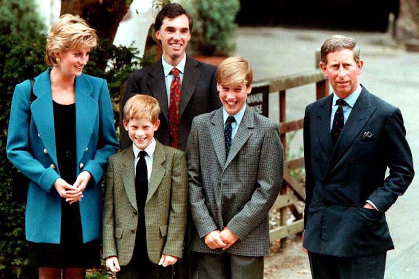 Princess Diana and Prince Charles stand smiling with their two sons, alongside the Eton housemaster.