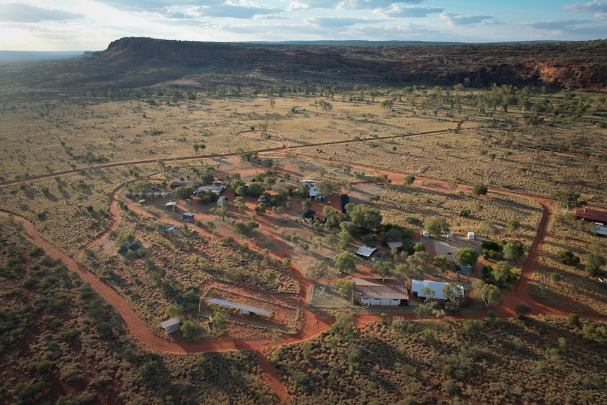 An aerial shot of a very small remote community with only a handful of buildings.