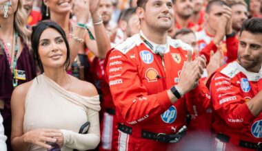 Kim K smiling in the crowd beneath Monaco podium next to Ferrari team members