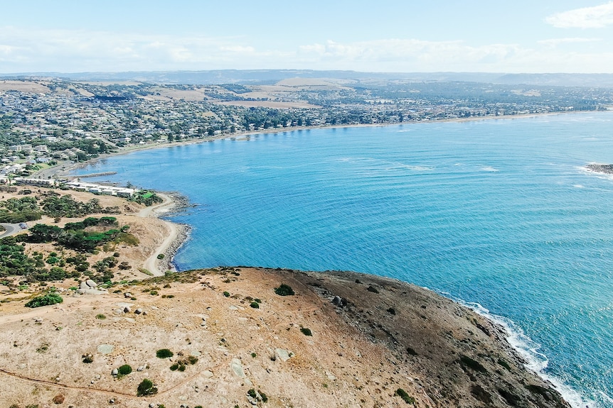 An overhead picture of a town on a sweeping coastline