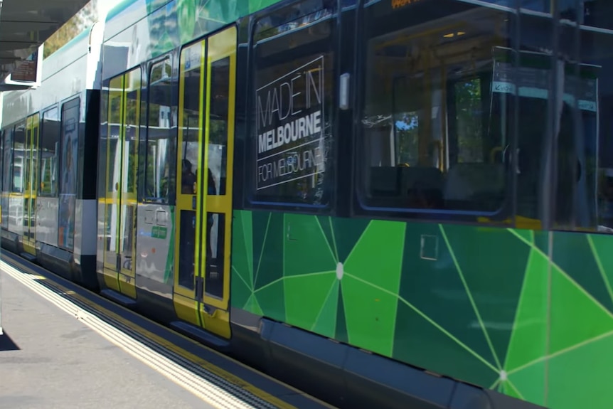 Green Melbourne tram terminates at tram stop.