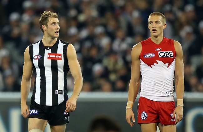 Ben Reid (L) of the Magpies and brother Sam Reid of the Swans look ahead during the round nine AFL match between the Collingwood Magpies and the Sydney Swans at Melbourne Cricket Ground on May 24, 2013 in Melbourne, Australia. 