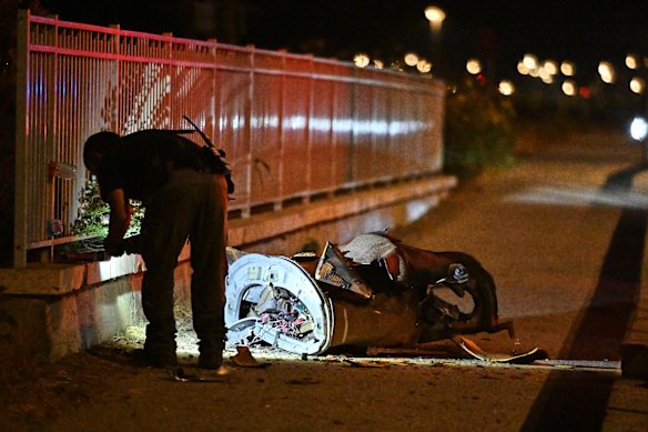 Security forces examine a fragment of an intercepted Iranian missile in northern Israel, early on Monday.