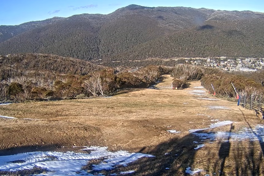 snow speckles hills and mountains after it melted