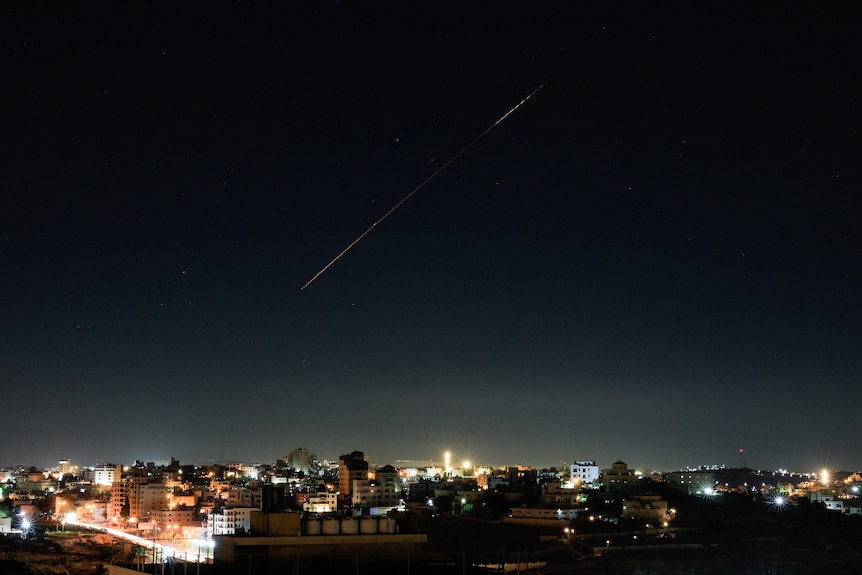 A streak of light can be seen across the night sky 