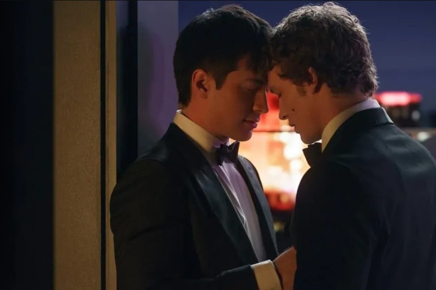 Two men in tuxedos with their foreheads touching.