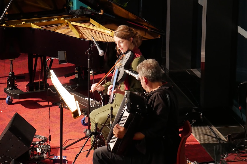 A wide shot of two people on stage
