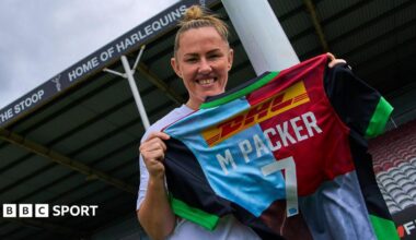 Marlie Packer holds up a Harlequins shirt with her name on it