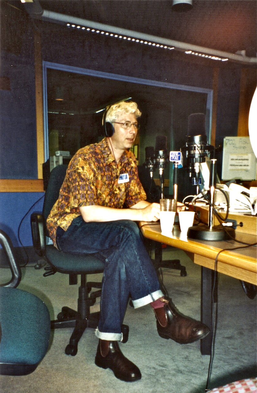 A younger Jerry Coleby-Williams with bleached blonde hair sits at an ABC radio desk