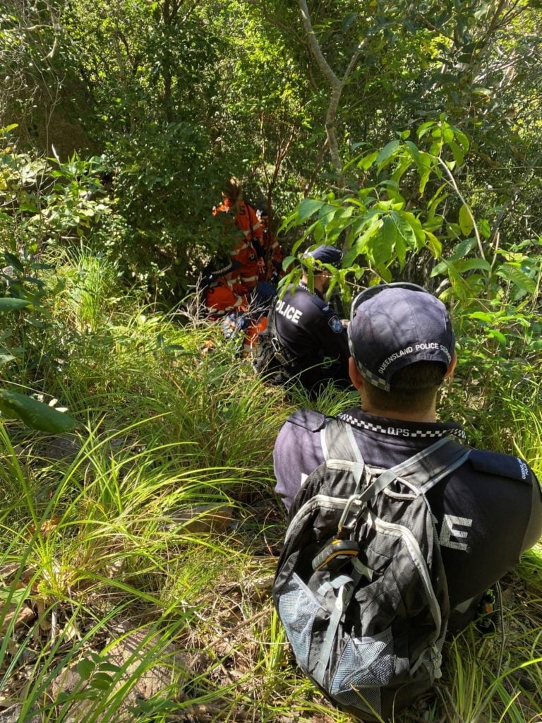A photo of police and emergency service personnel in bushland.